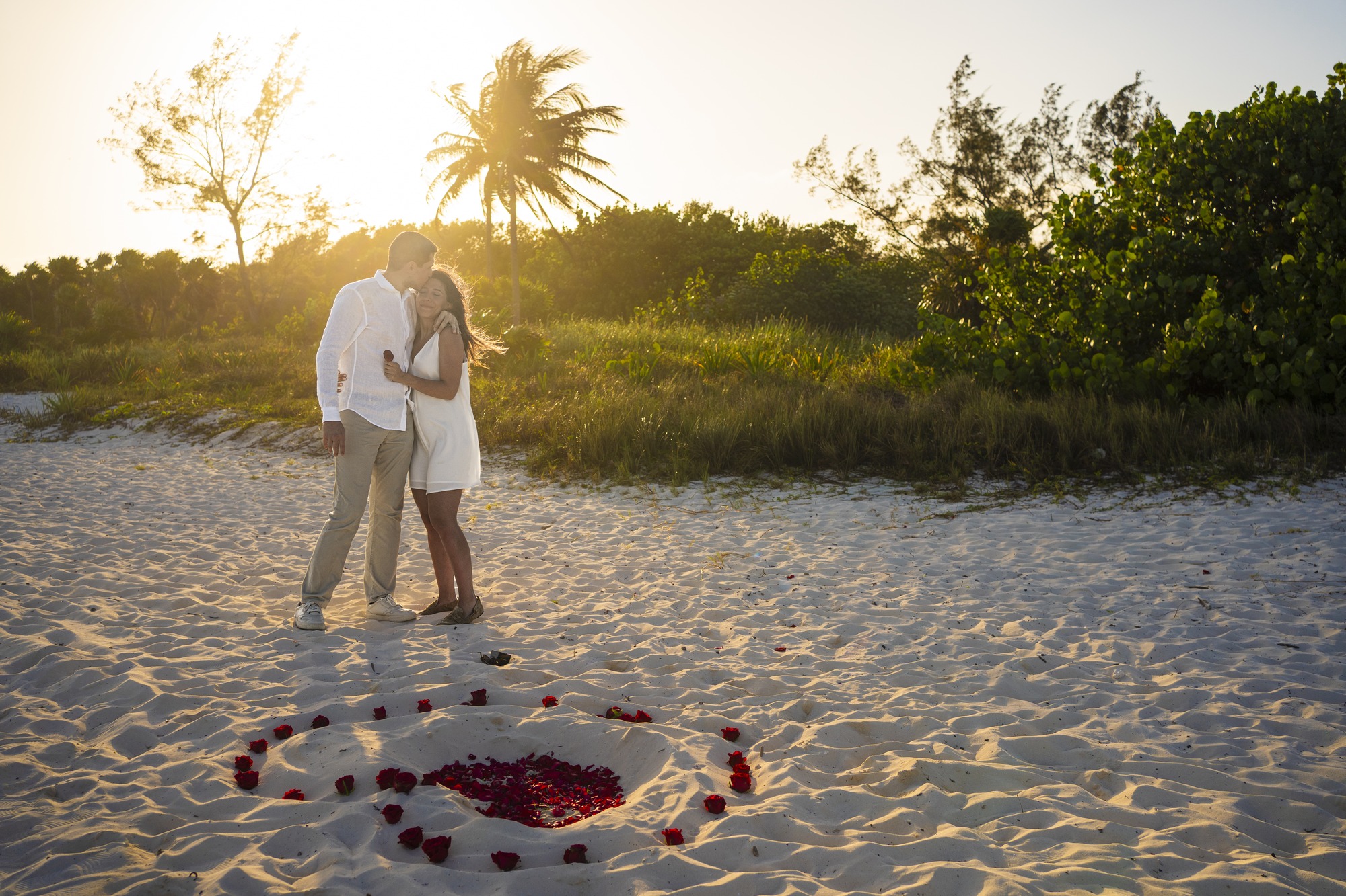 Beach proposal at sunset with a rose-petal heart in the sand, Isla Mujeres